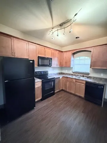 a kitchen with stainless steel appliances and wooden cabinets
