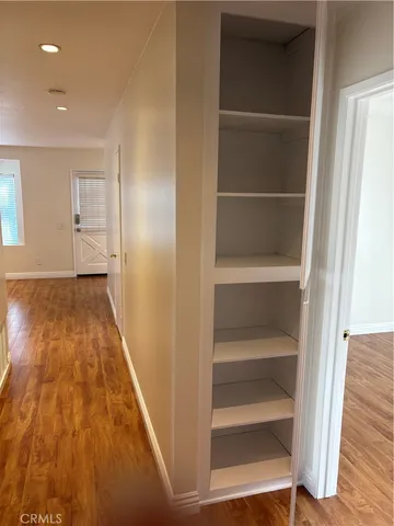 a view of walk in closet with empty racks