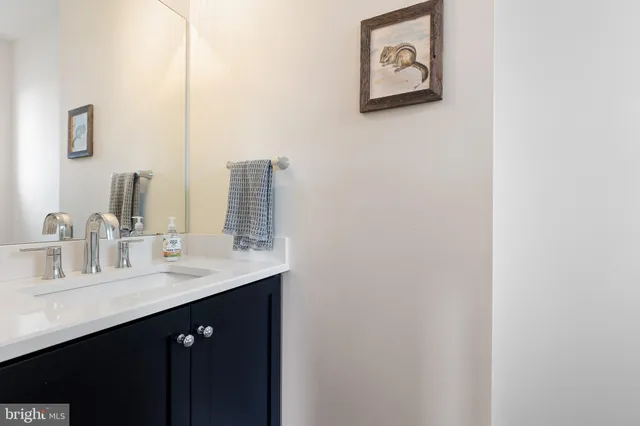 a kitchen with kitchen island granite countertop a sink a stove a dining table and chairs