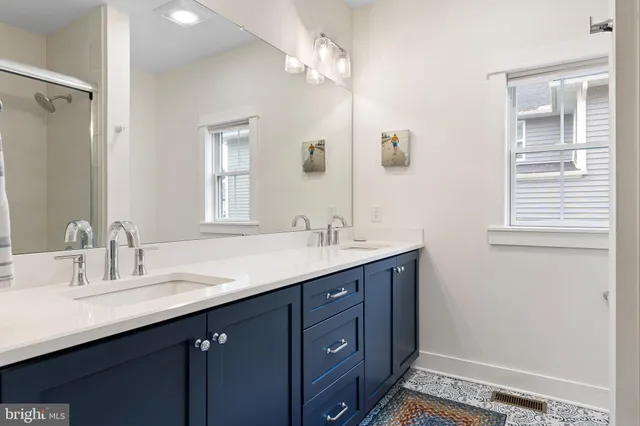 a bathroom with a tub sink and mirror