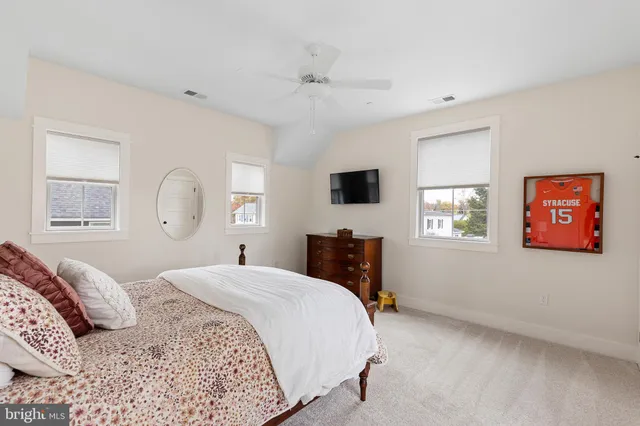 a spacious bathroom with a double vanity sink a mirror and a window