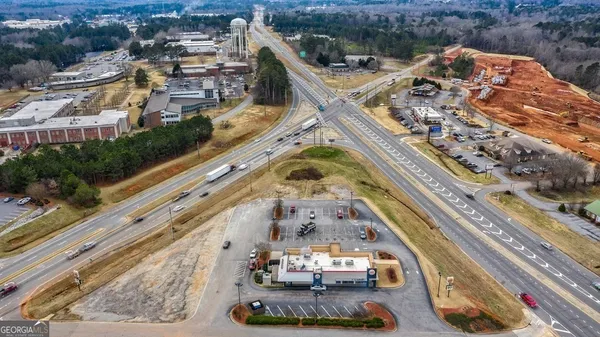 an aerial view of a house with a yard and lake view