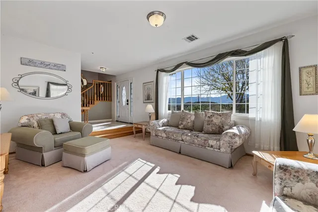a bathroom with a granite countertop sink and a window