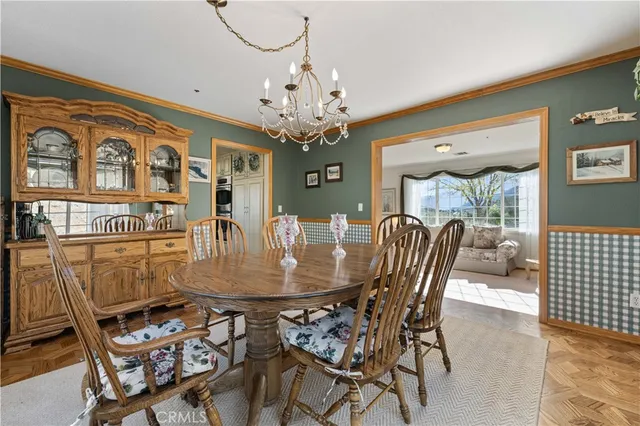 a view of a dining room with furniture large windows and wooden floor
