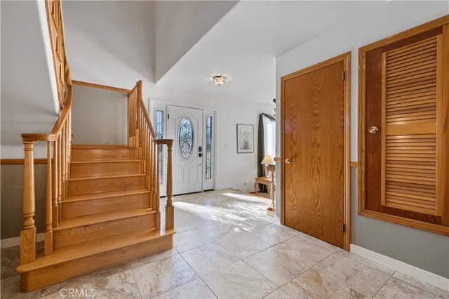 a dining room with furniture a chandelier and wooden floor