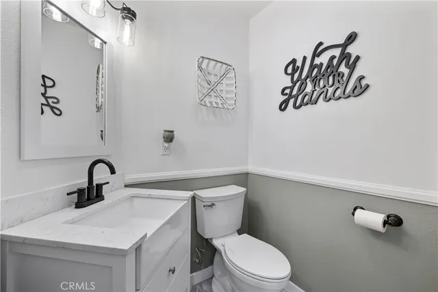 a living room with furniture a chandelier couches and a fireplace