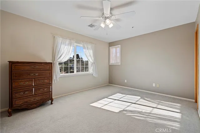 a view of a large building with mountains in the background