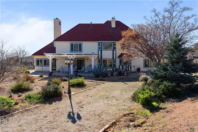 a view of a wooden house with a yard