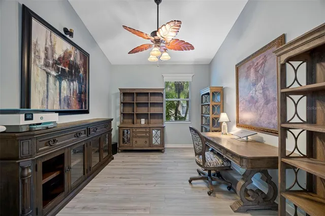 a kitchen with stainless steel appliances a stove a refrigerator and a bookshelf