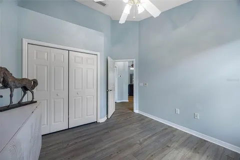 a view of a hallway with wooden floor and closet