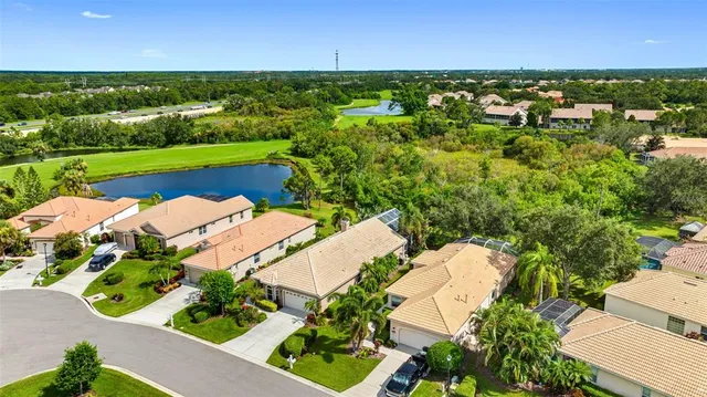 an aerial view of a houses with a lake view