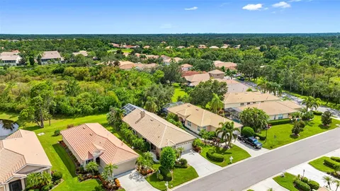 an aerial view of residential houses with outdoor space and street view