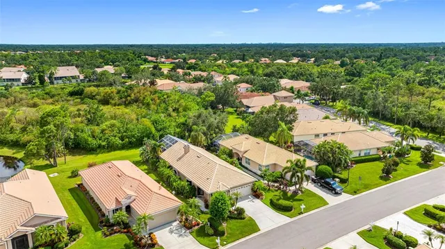an aerial view of residential houses with outdoor space and street view