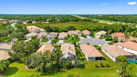 an aerial view of residential houses with outdoor space and street view