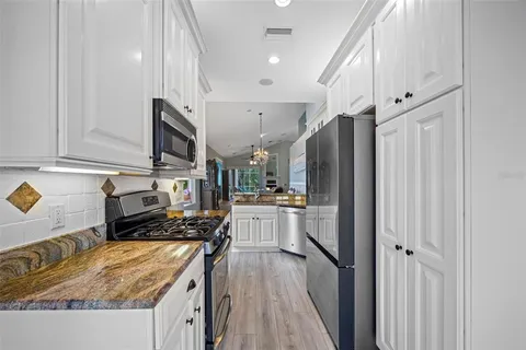 a kitchen with a sink stainless steel appliances and counter space