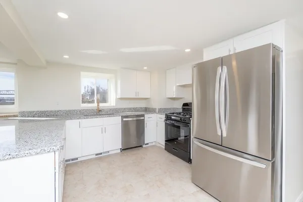 a kitchen with a refrigerator and a sink