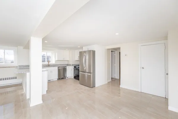 a view of a kitchen with refrigerator and microwave