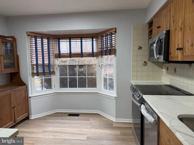 a kitchen with a fridge and a sink