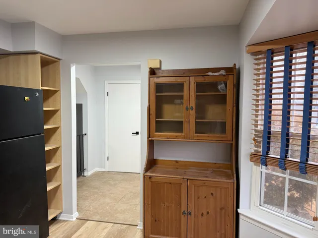 a kitchen with a refrigerator and a cabinets