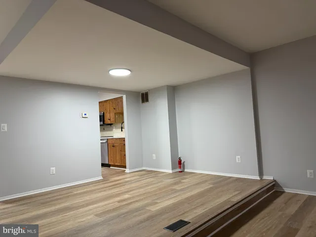 a view of an empty room and wooden floor