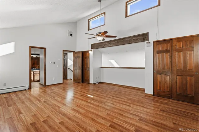 a view of empty room with wooden floor
