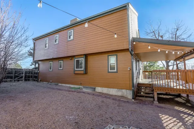 a backyard of a house with barbeque oven table and chairs