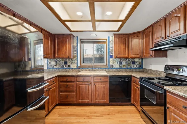 a kitchen with stainless steel appliances granite countertop a stove and a sink