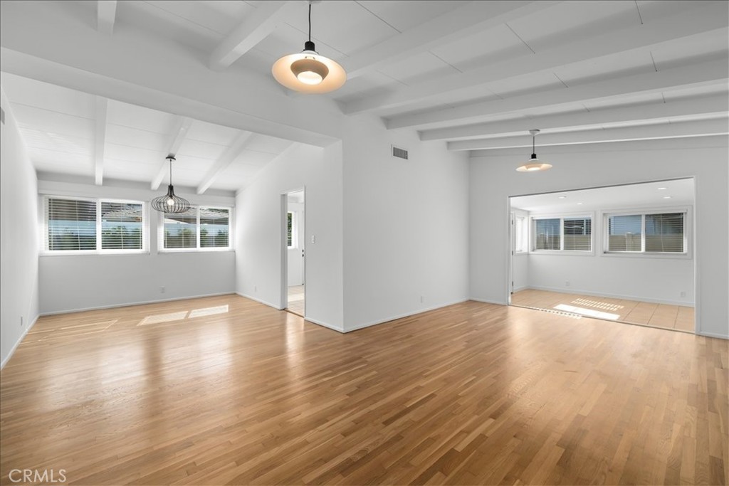 10802 Deshire Place Culver City, CA 90230 - Photo 13 of 50 a view of an empty room with wooden floor and windows