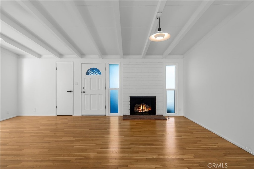 10802 Deshire Place Culver City, CA 90230 - Photo 14 of 50 a view of living room with wooden floor and fireplace