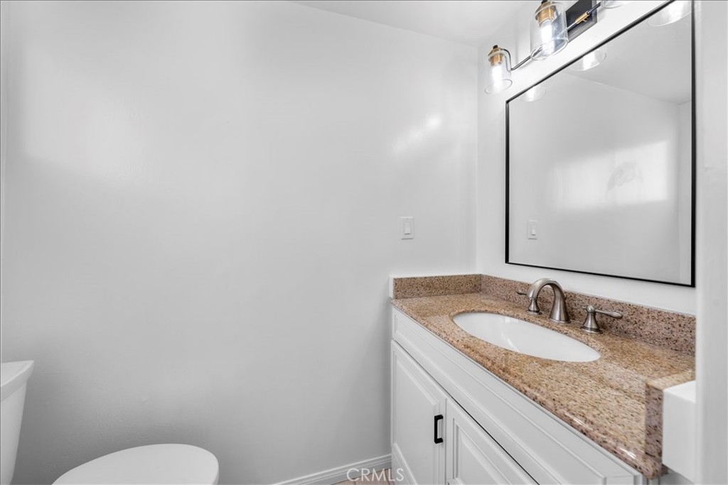 10802 Deshire Place Culver City, CA 90230 - Photo 17 of 50 a bathroom with a granite countertop sink and a mirror
