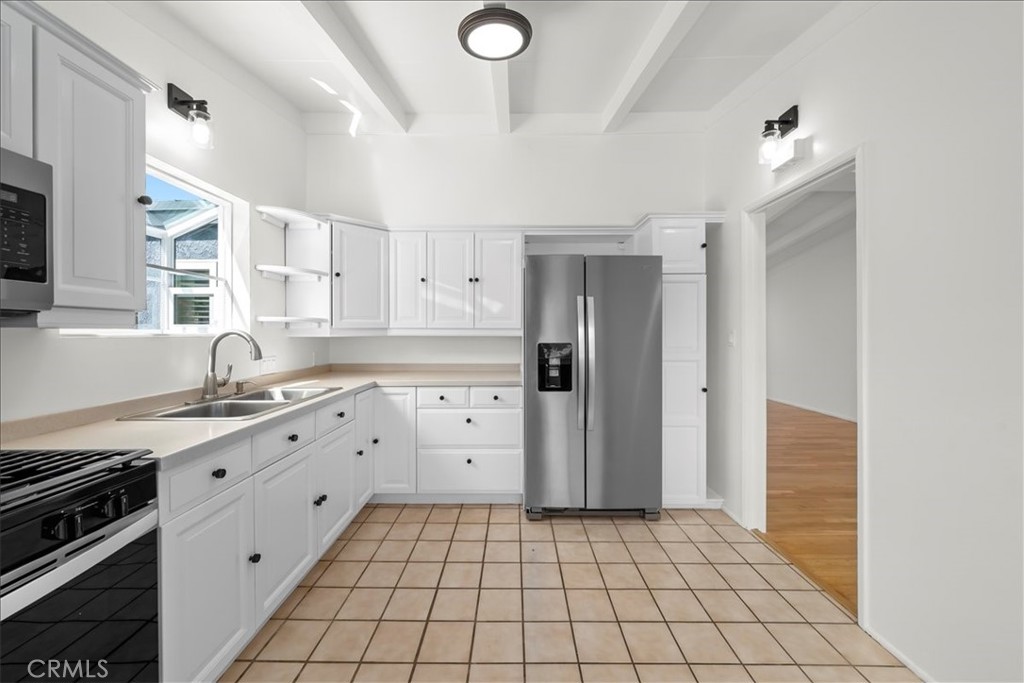 10802 Deshire Place Culver City, CA 90230 - Photo 22 of 50 a kitchen with stainless steel appliances a stove a sink and a refrigerator