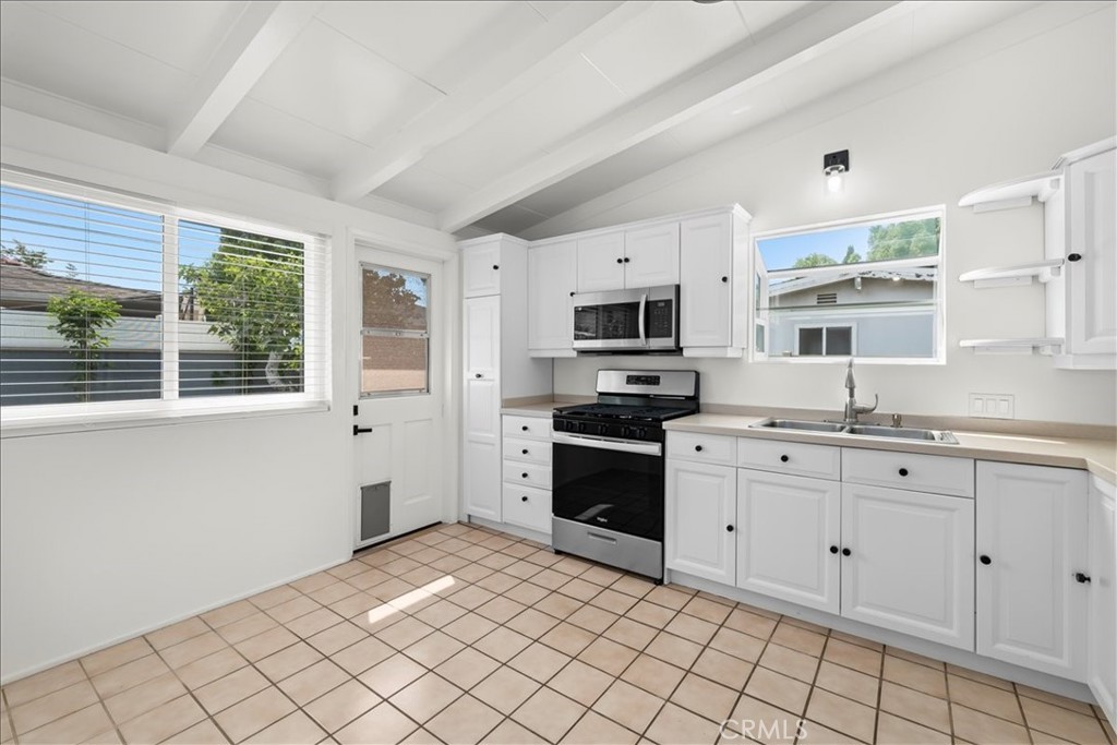 10802 Deshire Place Culver City, CA 90230 - Photo 24 of 50 a kitchen with stainless steel appliances granite countertop a refrigerator and a sink