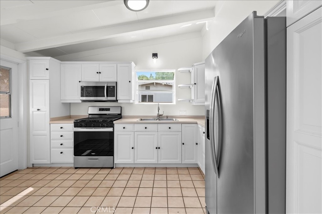 10802 Deshire Place Culver City, CA 90230 - Photo 25 of 50 a kitchen with stainless steel appliances a refrigerator sink and cabinets