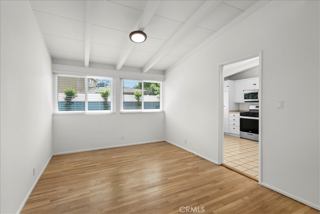 10802 Deshire Place Culver City, CA 90230 - Photo 36 of 50 an empty room with wooden floor and windows