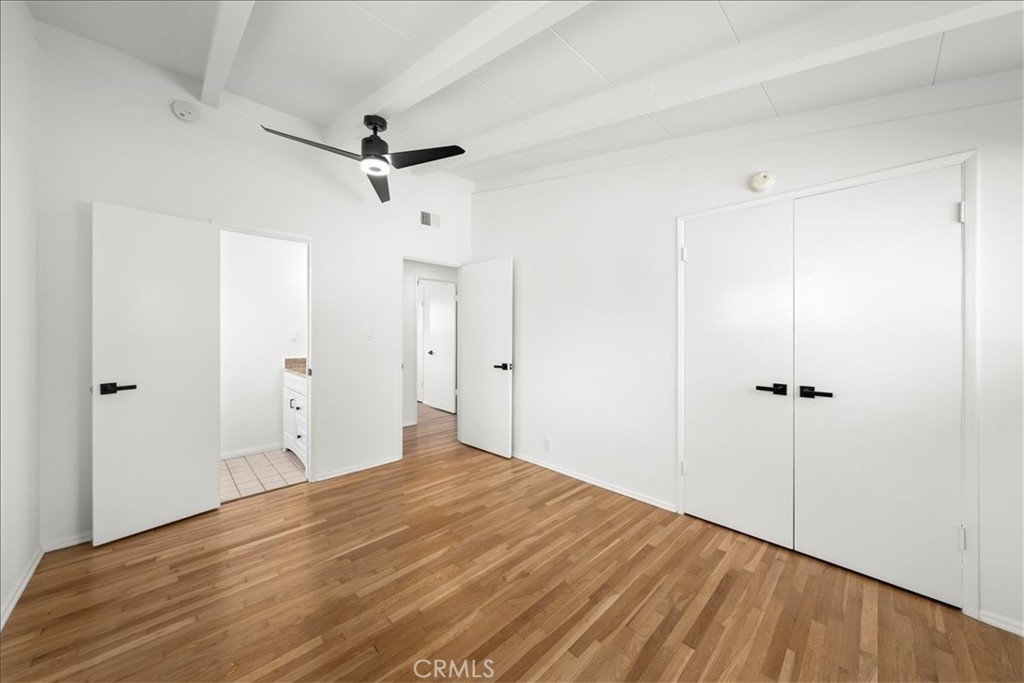 10802 Deshire Place Culver City, CA 90230 - Photo 39 of 50 a view of a room with a ceiling fan wooden floor and closet area