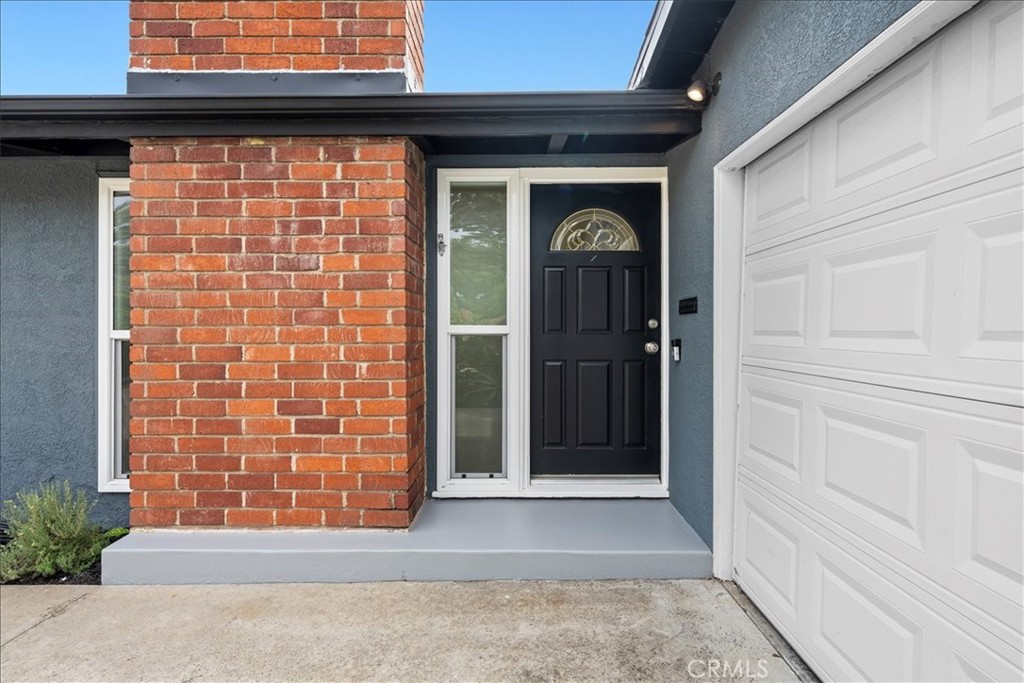 10802 Deshire Place Culver City, CA 90230 - Photo 4 of 50 a front view of a house with a blue gate