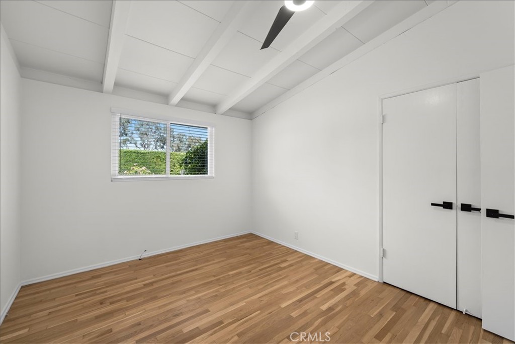 10802 Deshire Place Culver City, CA 90230 - Photo 43 of 50 an empty room with wooden floor and window