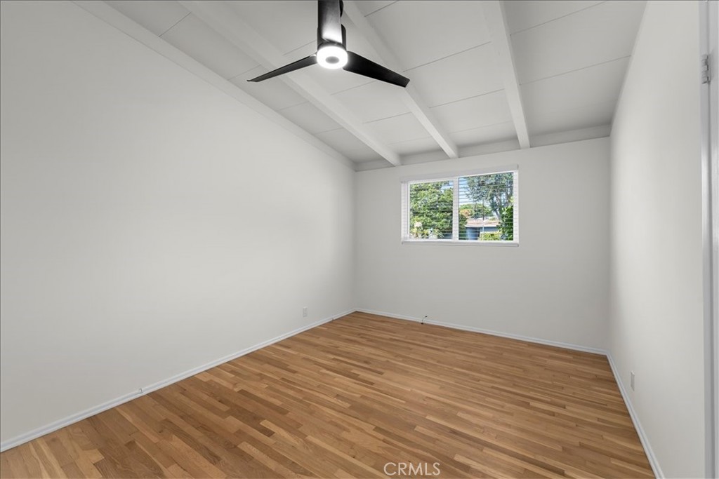 10802 Deshire Place Culver City, CA 90230 - Photo 45 of 50 an empty room with wooden floor chandelier fan and windows