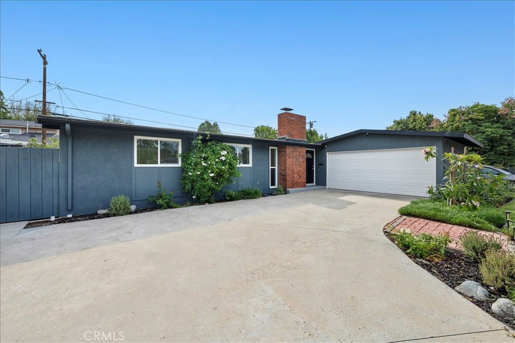 10802 Deshire Place Culver City, CA 90230 - Photo 46 of 50 a front view of a house with a yard and garage