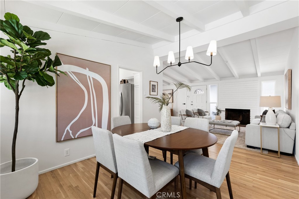 10802 Deshire Place Culver City, CA 90230 - Photo 6 of 50 a view of a dining room with furniture a fireplace and wooden floor
