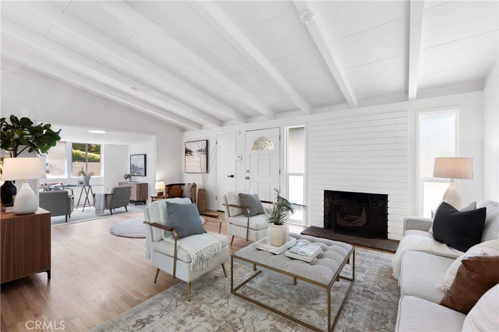 10802 Deshire Place Culver City, CA 90230 - Photo 7 of 50 a living room with furniture a fireplace with wooden floor