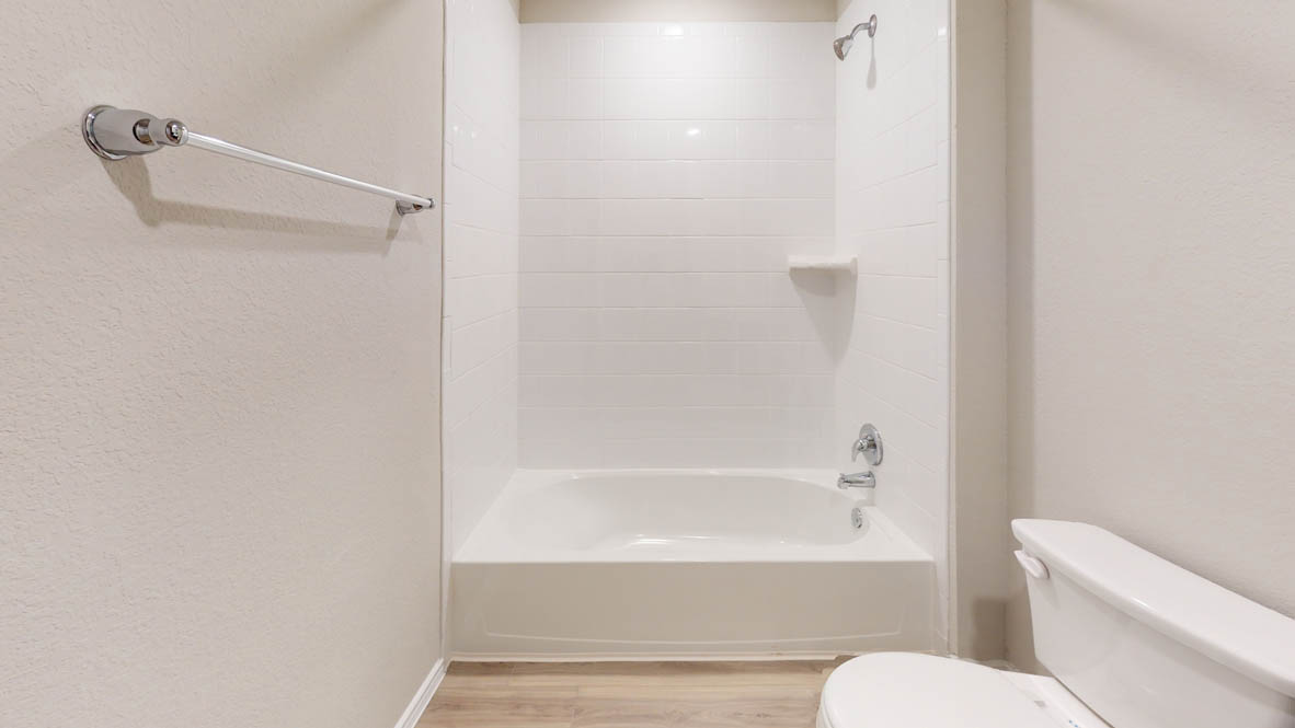 561 Hector Loop Georgetown, TX 78626 - Photo 28 of 30 a bathroom with a bathtub and a toilet