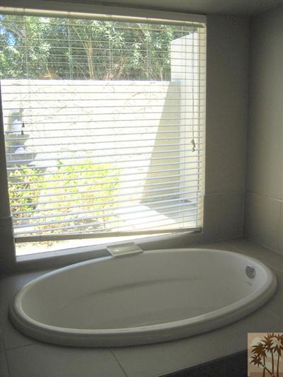 79350 4 Paths Lane Bermuda Dunes, CA 92203 - Photo 16 of 24 a bath tub sitting in a bathroom next to a window