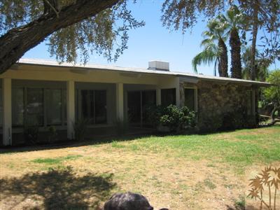 79350 4 Paths Lane Bermuda Dunes, CA 92203 - Photo 19 of 24 a view of backyard with potted plants and a large tree
