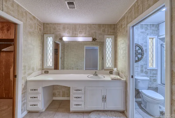 a bathroom with a double vanity sink a mirror and a shower