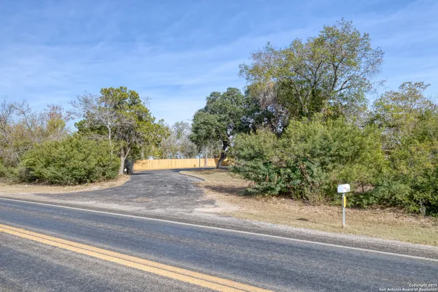 an empty room with fireplace and windows