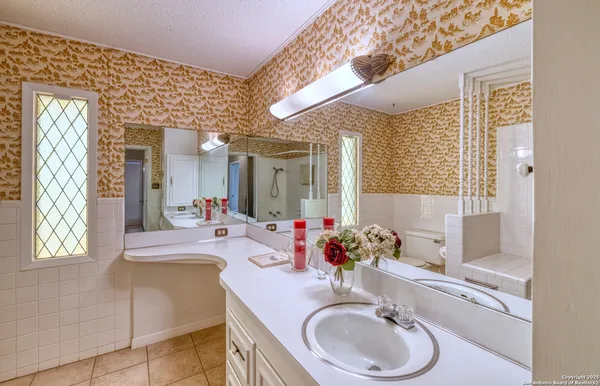 a view of a room with wooden floor and cabinets