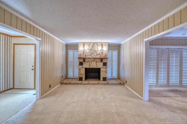 a view of an empty room with closet and a window
