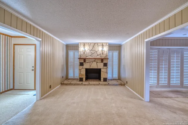 a view of an empty room with closet and a window