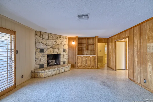 a view of a livingroom with a fireplace and window
